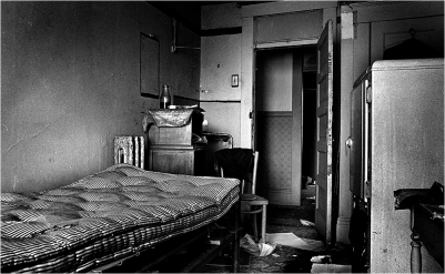 The person who lived in this room had his own large refrigerator. The bottle above the bed was for urine. The size of the rooms varied. Many were very small with just enough room for a bed and chair. This photo was shot with a wide-angle lens with my back against the wall.